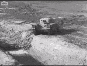 a black and white photo of a tank on a dirt road .