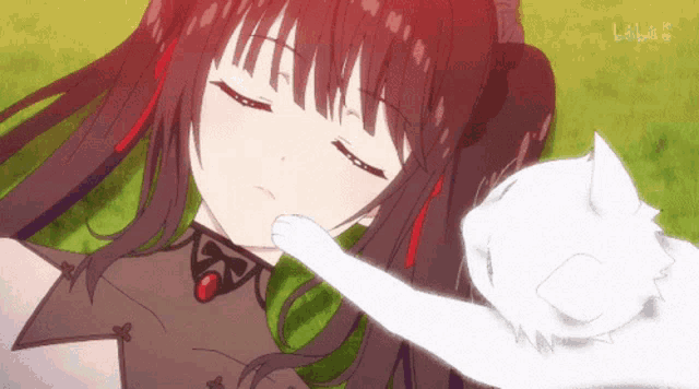 a girl is laying down with her eyes closed and a white cat laying on her chest