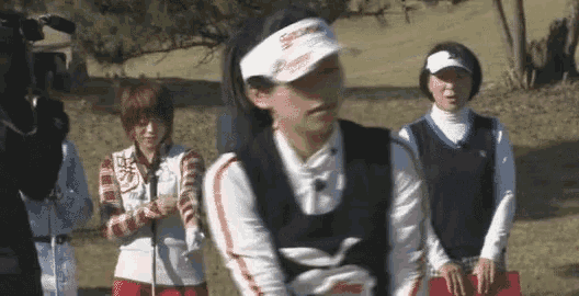a woman wearing a white visor that says srixon