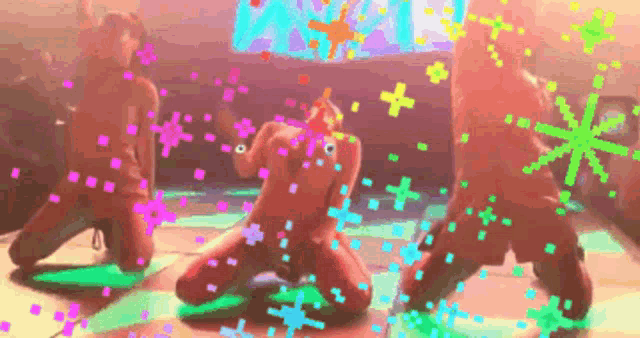 a group of people are kneeling down and dancing in a room surrounded by glowing dots .