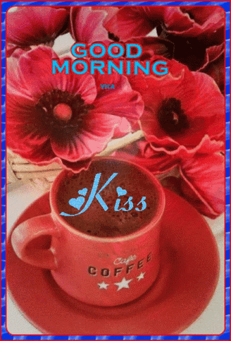 a cup of coffee on a saucer with the word kiss on it