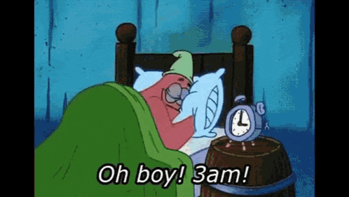 patrick star from spongebob squarepants is sleeping in a bed next to an alarm clock and a barrel .