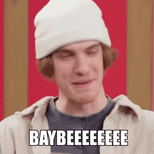 a man wearing a white beanie says baybeeeeeee
