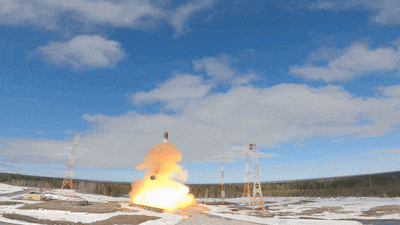 a rocket is being launched into the air with a blue sky in the background