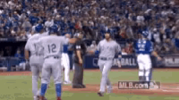 a group of baseball players are standing on a baseball field during a game .