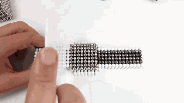 a person is holding a bunch of balls in their hands