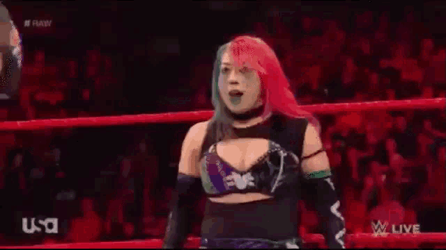 a woman with red hair is standing in a ring .