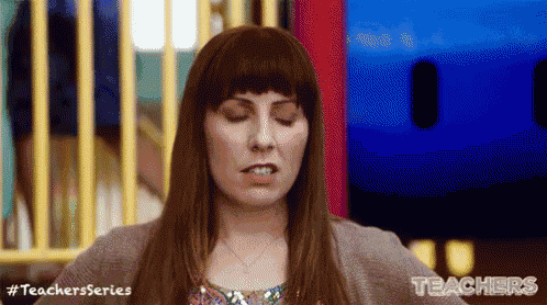 a woman is making a funny face with her eyes closed in front of a fence .