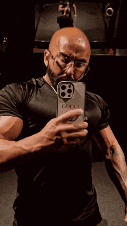 a man taking a picture of himself in a mirror with a phone that has the number 88 on it
