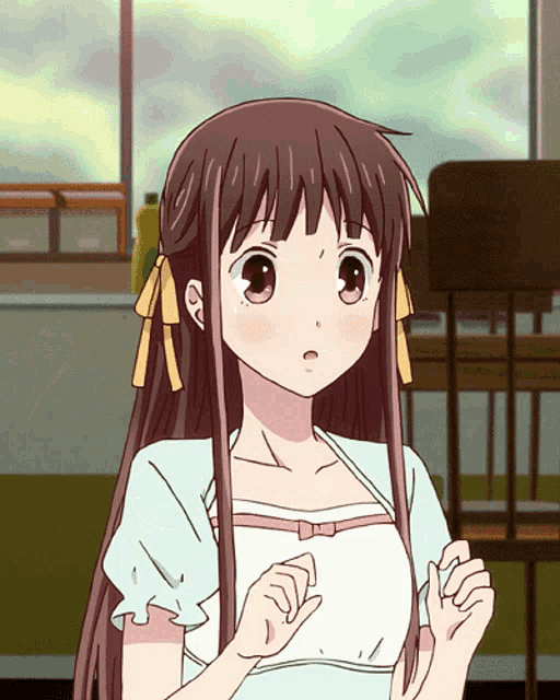 a girl with long brown hair is wearing a white shirt and bows in her hair