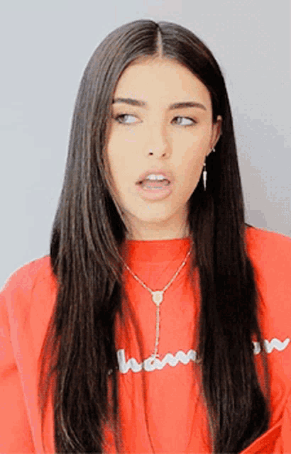 a woman wearing a red shirt that says champion