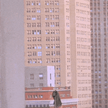 a man in a robin costume is laying on a man in a batman suit