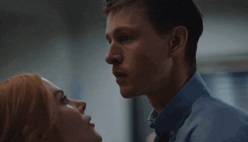 a man and a woman are looking at each other with their eyes closed