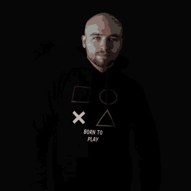 a man wearing a black hoodie that says born to play on it