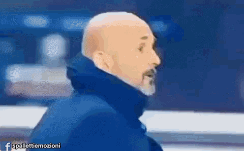 a bald man with a beard is wearing a blue jacket with the hashtag spallettiemozioni on the bottom