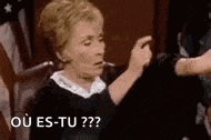 a woman is sitting in a chair talking to another woman and says `` ou es-tu?? '' .