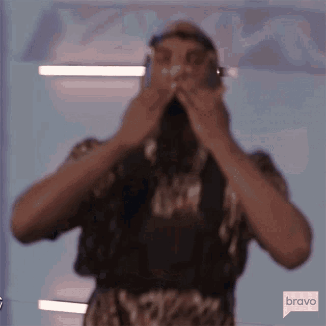 a blurry picture of a man wearing headphones covering his face .