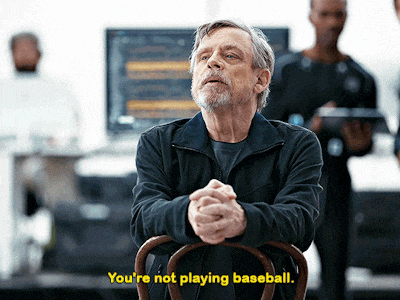 a man sitting in a chair with the words " you 're not playing baseball " below him
