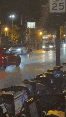 a sign that says little bar is above the street