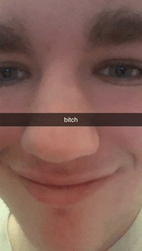 a close up of a man 's face with the word bitch written on it