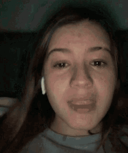 a close up of a woman 's face with a tear coming out of her eye