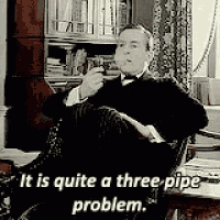 a man in a tuxedo is sitting in a chair smoking a pipe .
