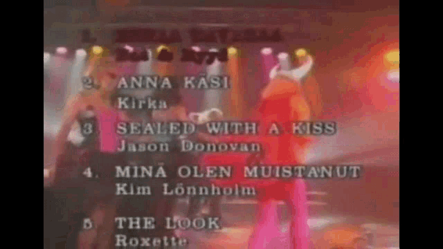 a group of people standing on a stage with the words sealed with a kiss