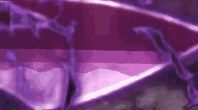 a close up of a purple background with a few lines of light coming out of it .