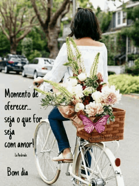 a woman is riding a bicycle with flowers in a basket
