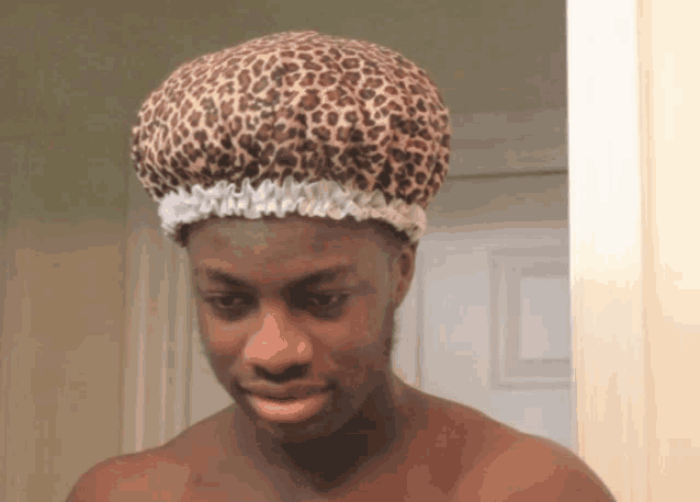 a man wearing a leopard print shower cap