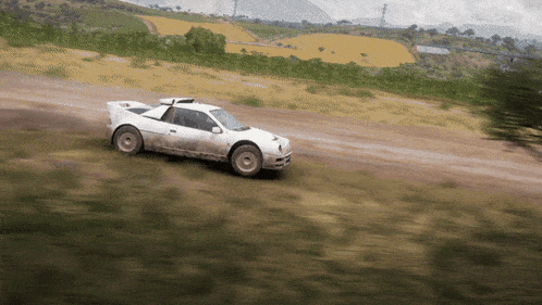 a white race car is driving down a dirt road