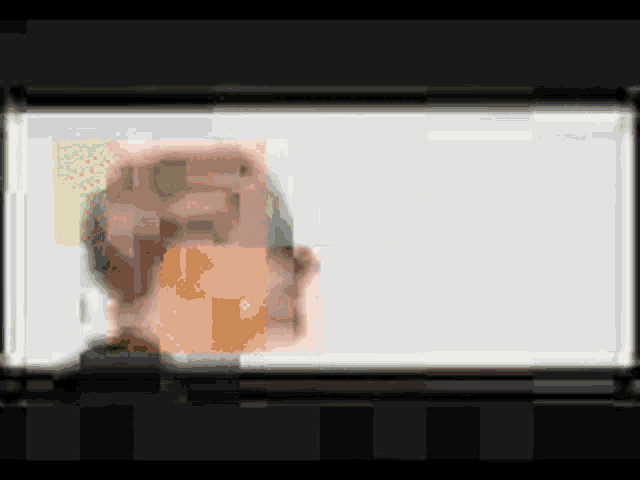a blurry picture of a person 's face is being displayed on a white background .