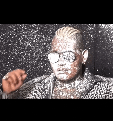 a man wearing sunglasses is covered in powdered sugar
