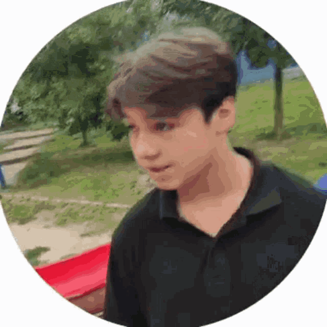 a young boy in a black shirt is standing in a circle
