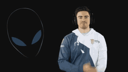 a man wearing headphones and a monster energy sweatshirt