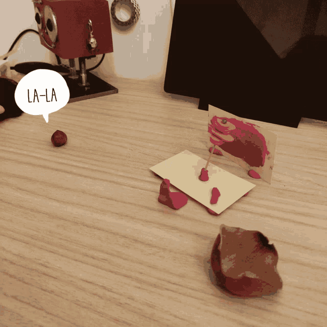 a wooden table with a speech bubble that says la-la on it
