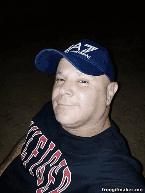 a man wearing a hat that says armani has red hearts in his eyes