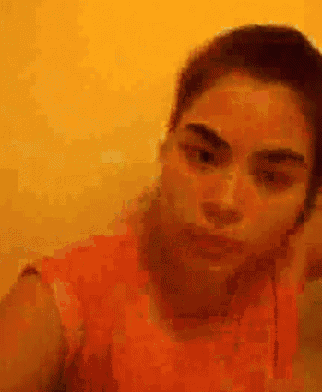 a blurry picture of a woman 's face with a yellow background .