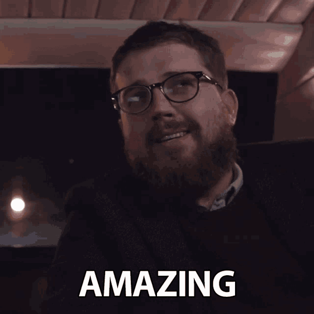 a man with glasses and a beard has the word amazing above him