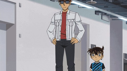 a man in a white jacket stands next to a boy in a black and blue shirt