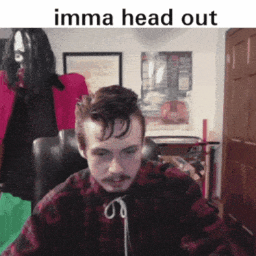 a man sitting in a chair with the words " imma head out " written above him