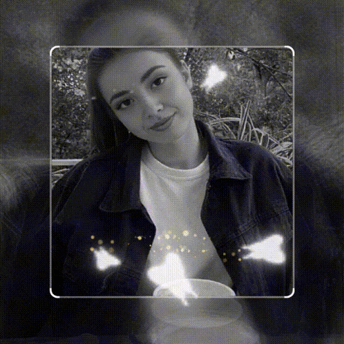 a black and white photo of a woman in a denim jacket and a white shirt