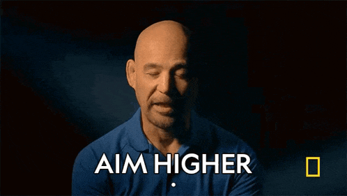 a man in a blue shirt with the words aim higher above him