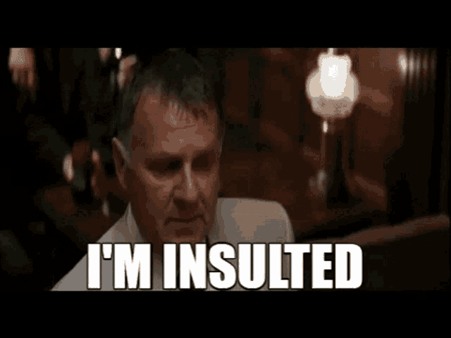 a man is being punched in the face by another man and the words `` i 'm insulted '' are visible .