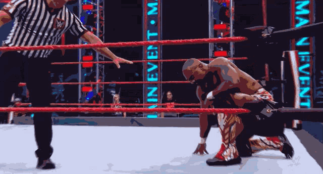 a wrestler is kneeling down in front of a man event banner