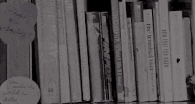 a shelf full of books including one titled " the measures of a man "