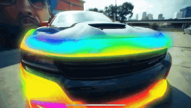 a close up of a car with a rainbow colored headlight