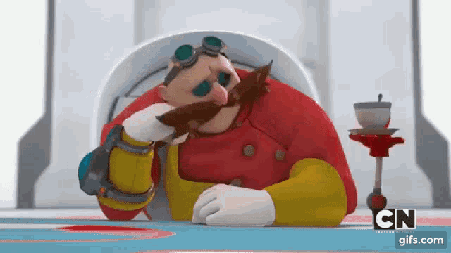 a cartoon character with a mustache and goggles is sitting at a table with his head resting on his hand .