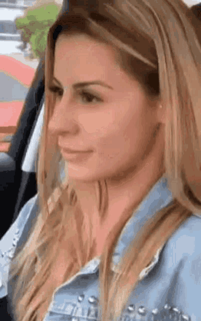 a woman is sitting in the back seat of a car .