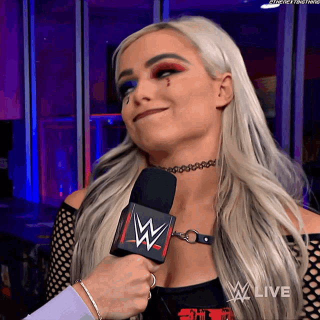 a female wrestler is being interviewed by a man in a wwe live broadcast